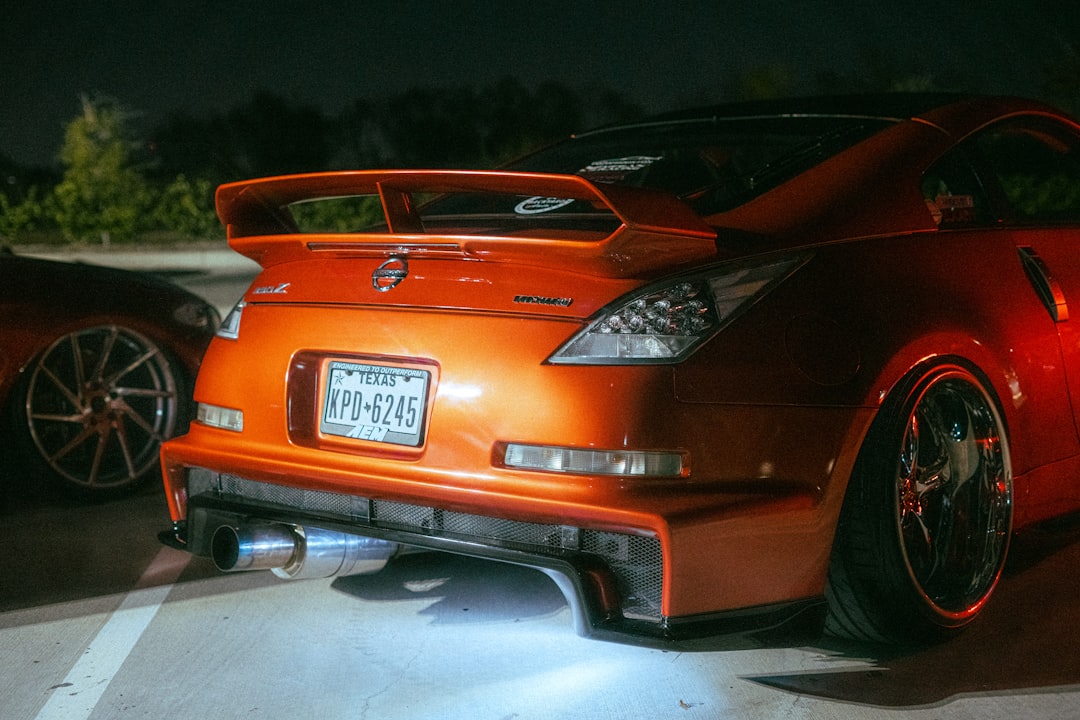an orange sports car parked in a parking lot