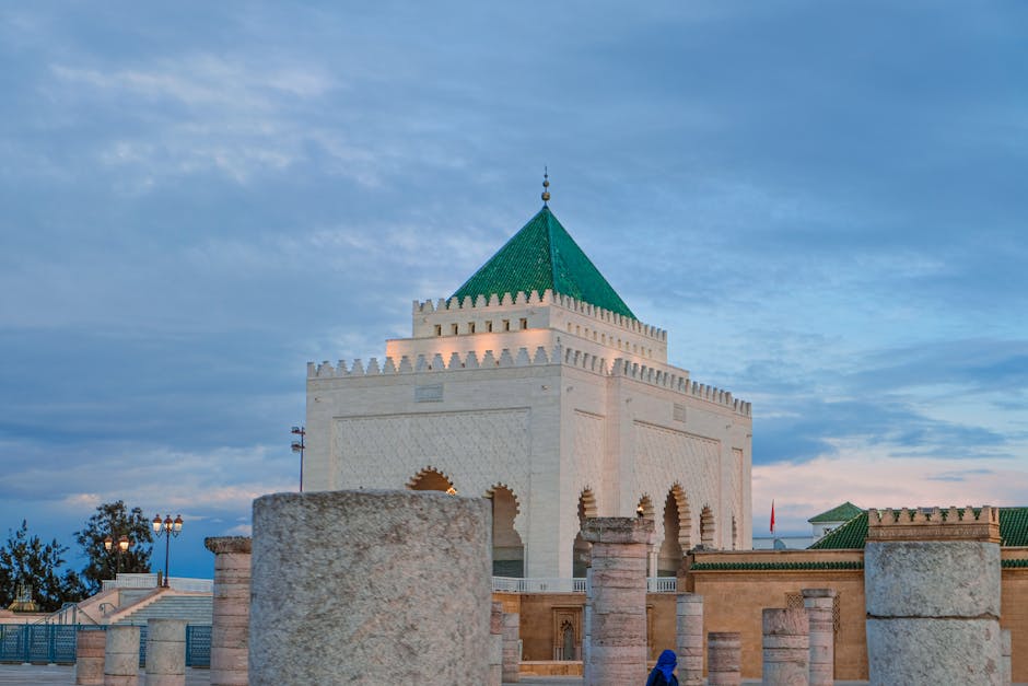 Historic Hassan Tower with Mausoleum in Rabat, Morocco at sunset, capturing Moroccan architecture.